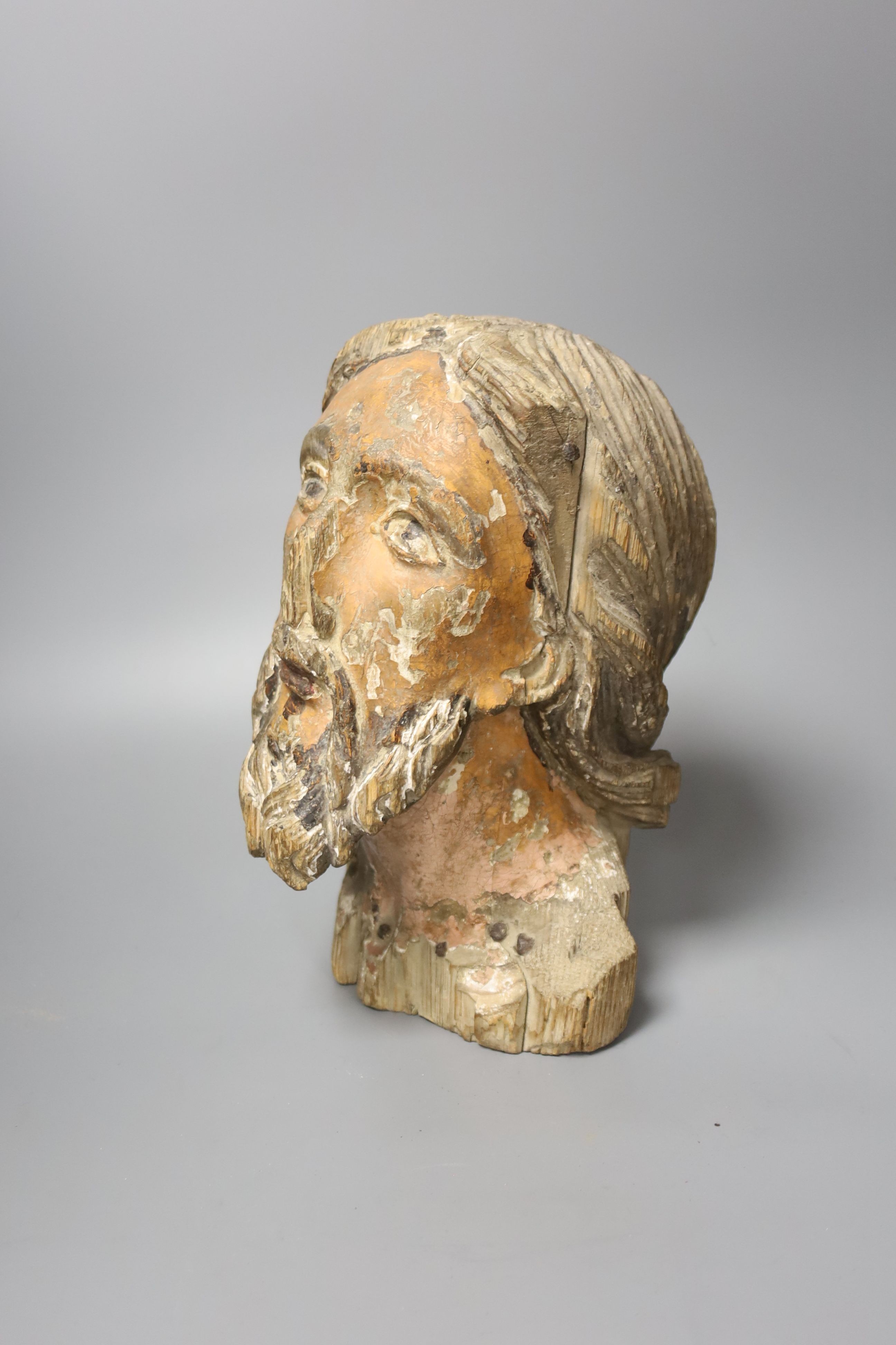 A 16th/17th century carved and polychrome painted pine head of a saint, 26cm